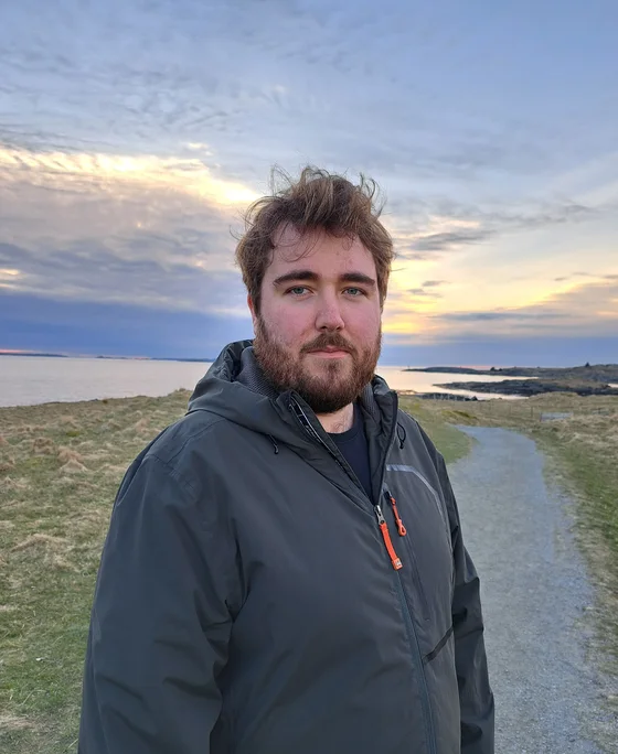 Michael on the west coast at sunset, with the sea behind him
